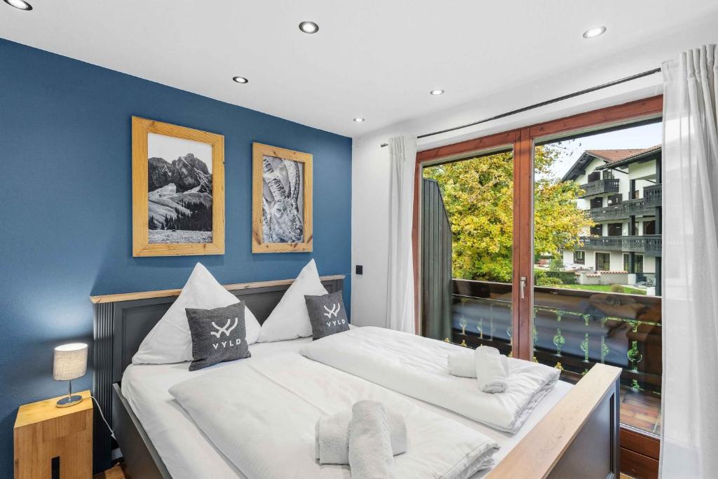 a bedroom with a bed and a large window at Ferienwohnung im Zentrum von Oberstaufen in Oberstaufen
