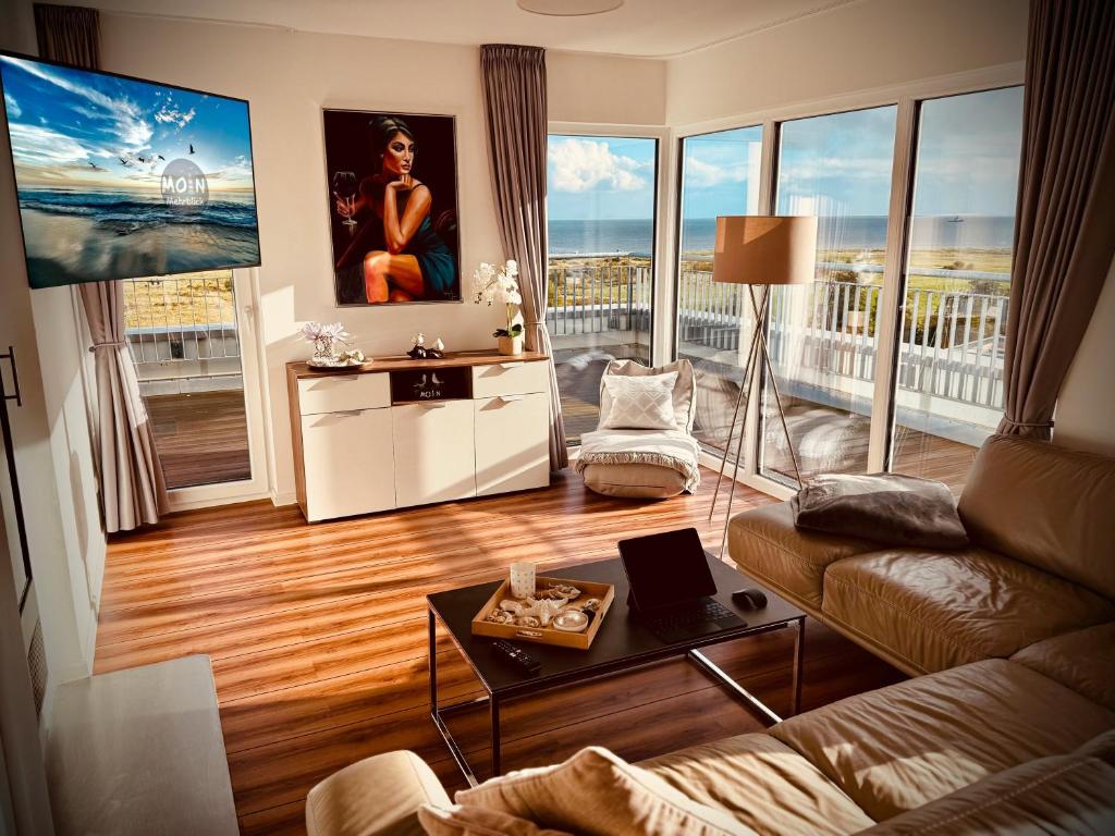 a living room with a couch and a table at Moin Mehrblick in Schillig
