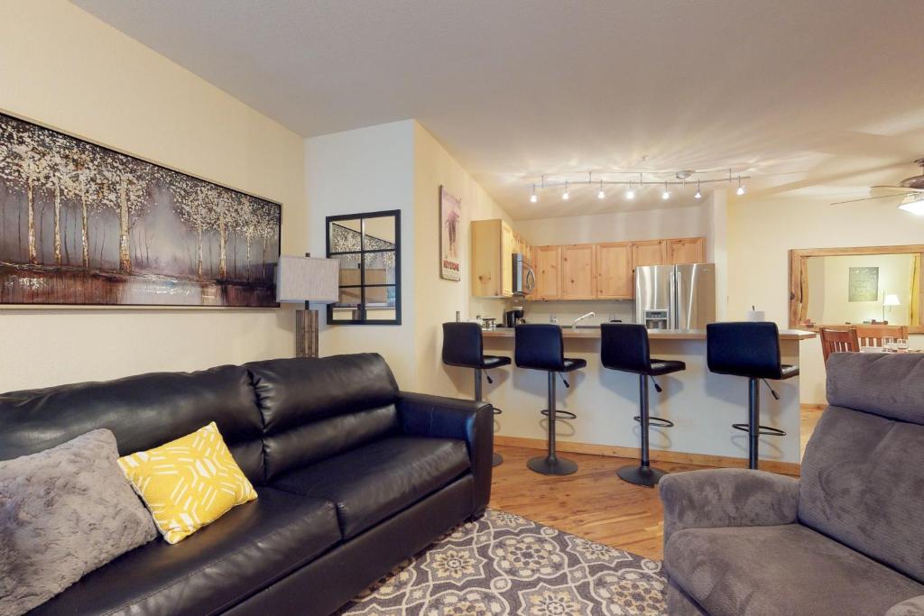 ein Wohnzimmer mit Couch und Küche in der Unterkunft Tenderfoot Lodge 2605 in Snake River Health Services Incorporated Heliport