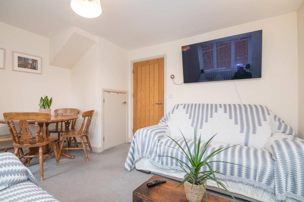 a living room with a couch and a table at Vine Mews - 2 Bed in Warwick