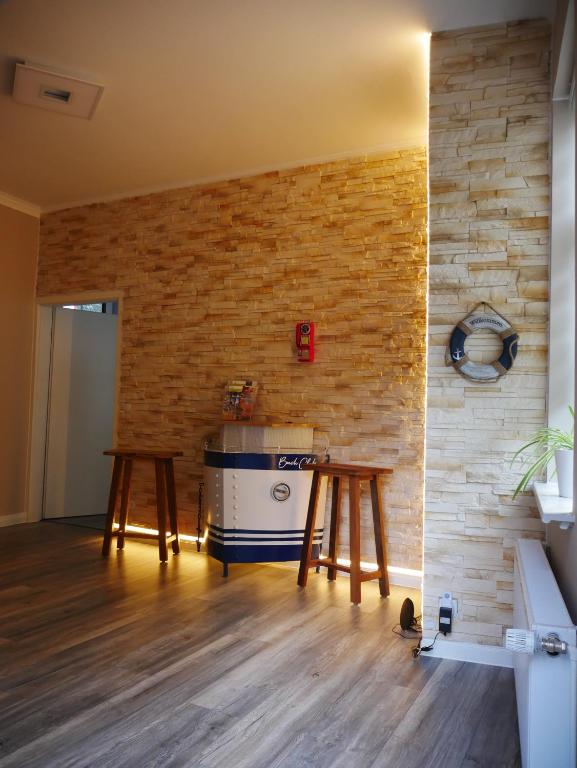 a kitchen with wooden tables and a brick wall at Ferienwohnung Abzuchthafen in Goslar