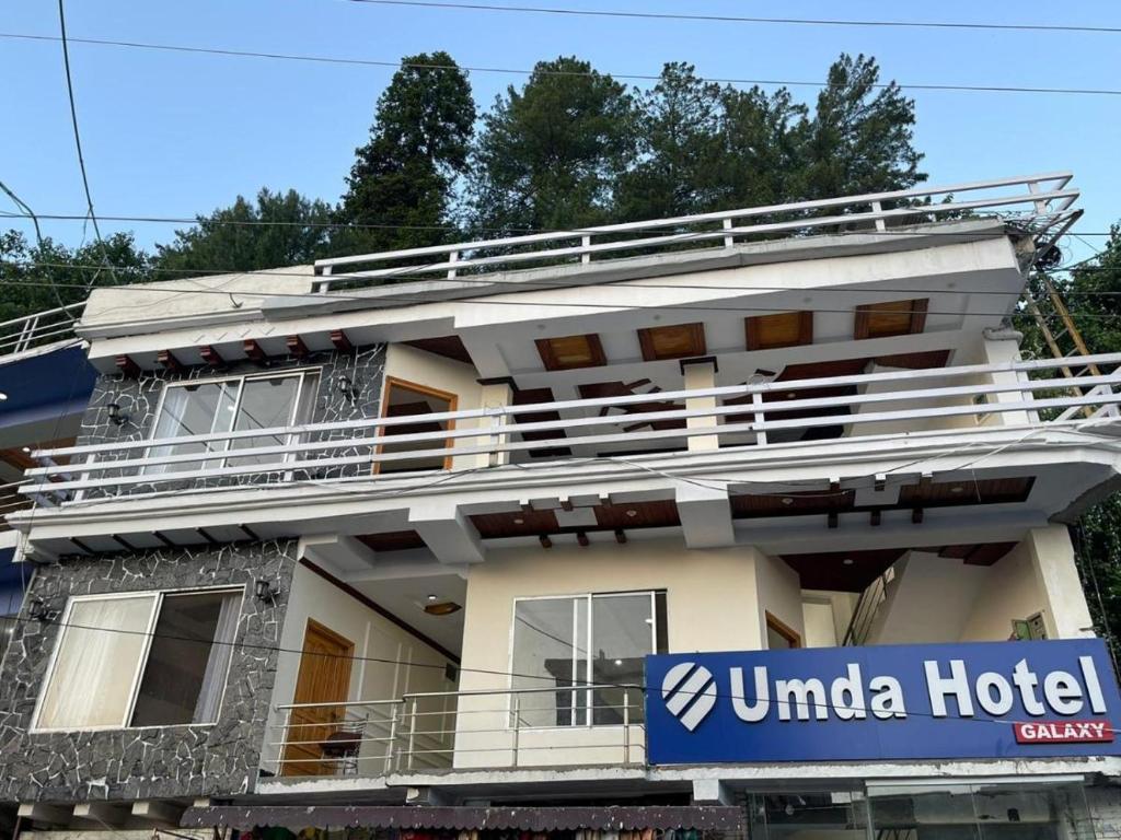 a building with a hotel sign in front of it at Umda Hotel Galaxy in Dargai