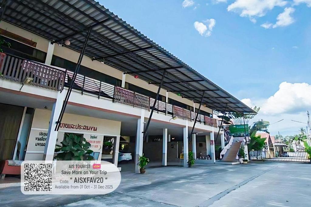 een groot gebouw met een bord ervoor bij Anchalee Garden Hotel in Ban Thuang Luang