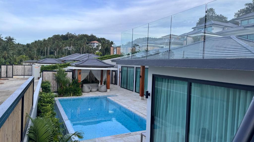 a house with a swimming pool in the backyard at Sunterra villa in Nathon Bay