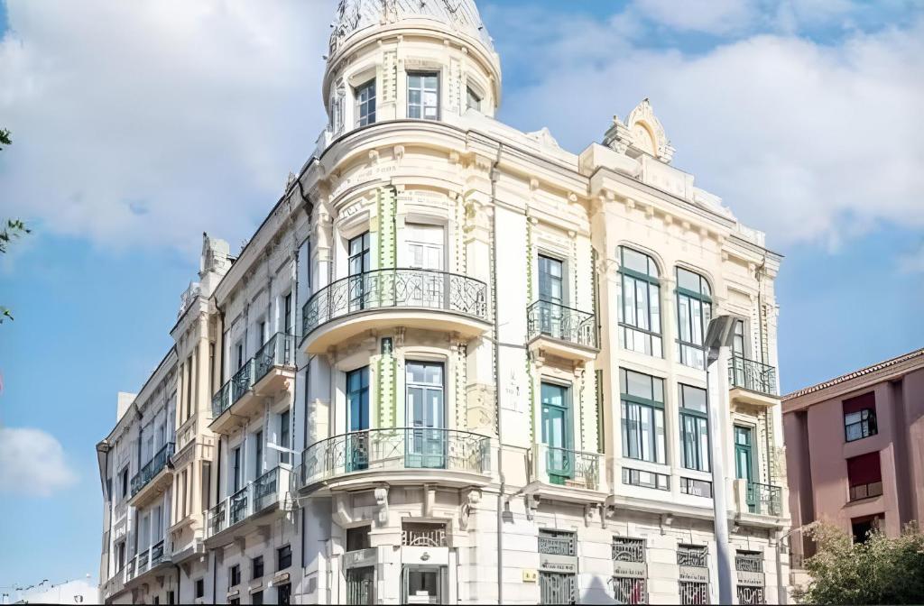 ein Gebäude mit einem Turm darauf in der Unterkunft Apartamento con calefacción, balcón y hermosas vistas in Posada de Llanes