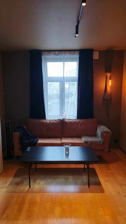 a living room with a couch and a coffee table at The Guest Apartment in Tromsø