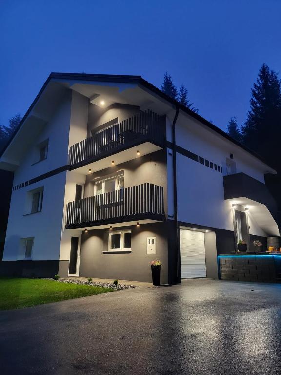 a large white building with a balcony on it at Green Garden House in Zreče
