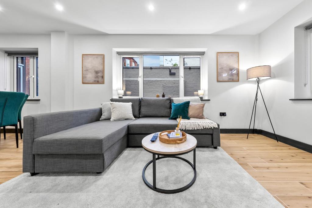 a living room with a couch and a table at Luxury 1 Bedroom Apartment sleeps 4 with terrace 10 min to tube in Finchley