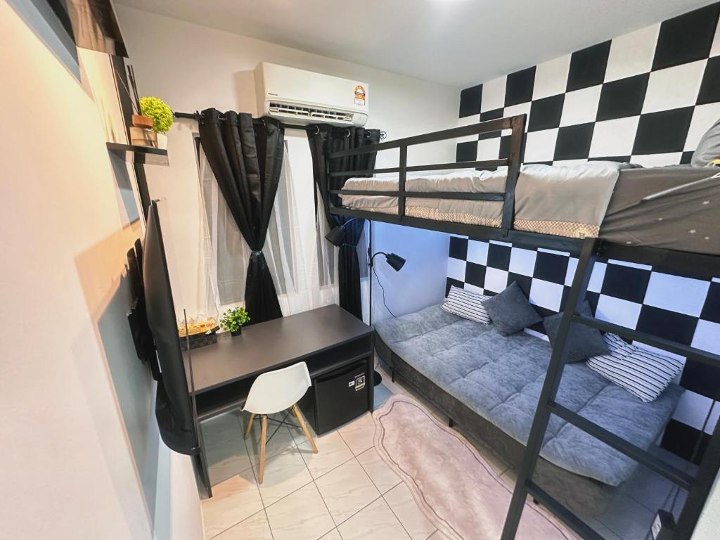 a dorm room with a desk and bunk beds at Unisuites Kampar Studio 5 min to UTAR TARC -3pax , 1 CP in Kampar