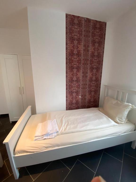 a bed in a room with a curtain on it at The City Apartment in Hannover