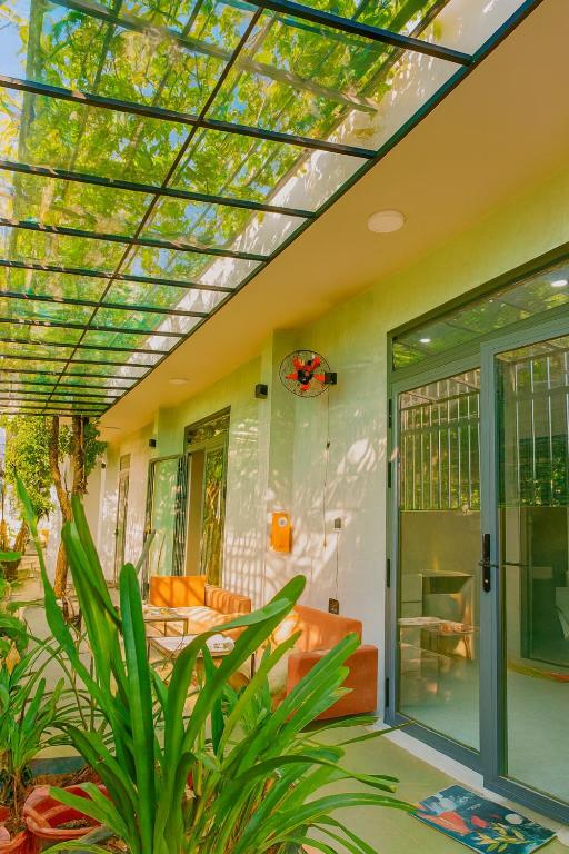 a conservatory with a skylight in a house at Happy House Sài Gòn in Ho Chi Minh City