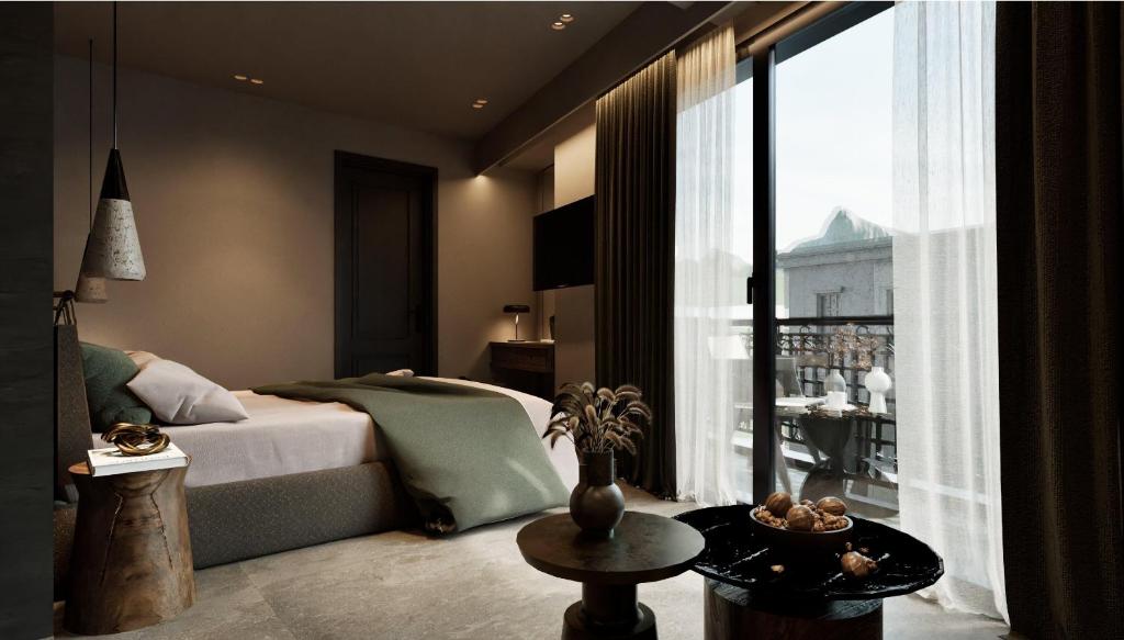 a bedroom with a bed and a large window at Alkioni Boutique Hotel in Pýli