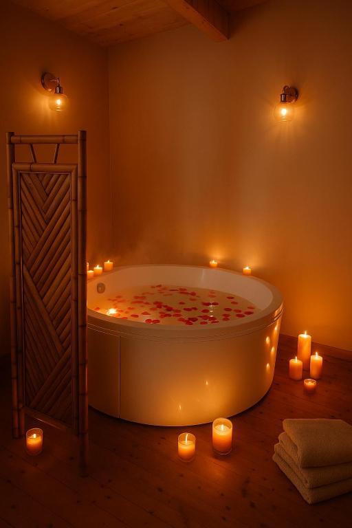 a bathroom with a bath tub with candles and lights at Chalet romantique & bucolique in Montignac-Charente