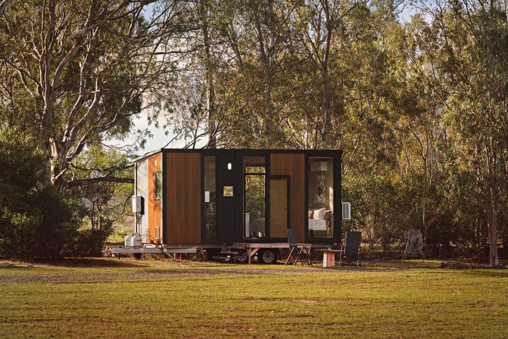 a tiny house sitting on a table in a field at Hollow Mountain Getaway 2 by Tiny Away in Laharum