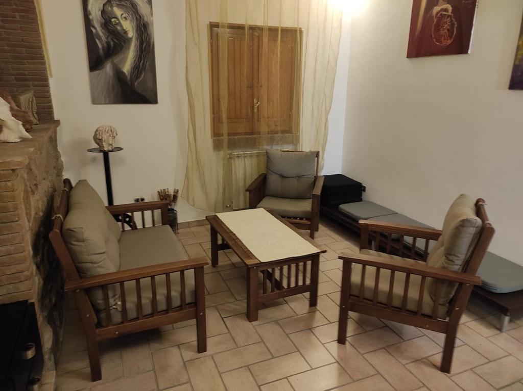 a living room with chairs and tables and a fireplace at casa vacanze in famiglia, il rustico della nonna in San Leucio del Sannio