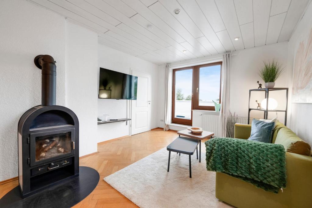a living room with a fireplace and a couch at Cosmic Living by Tayo Ajayi in Zwickau