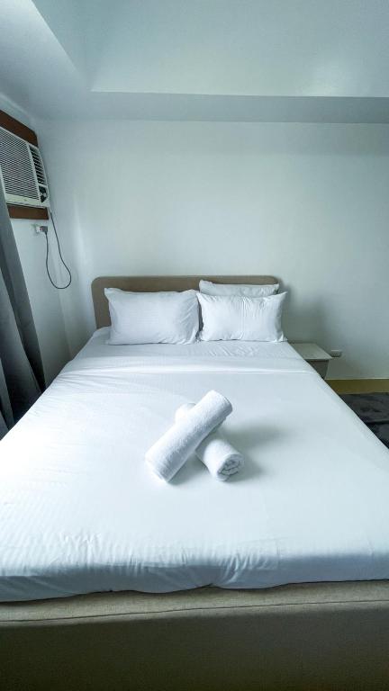a white bed with a book on top of it at Modern Comfort Studio with City Views in Molo