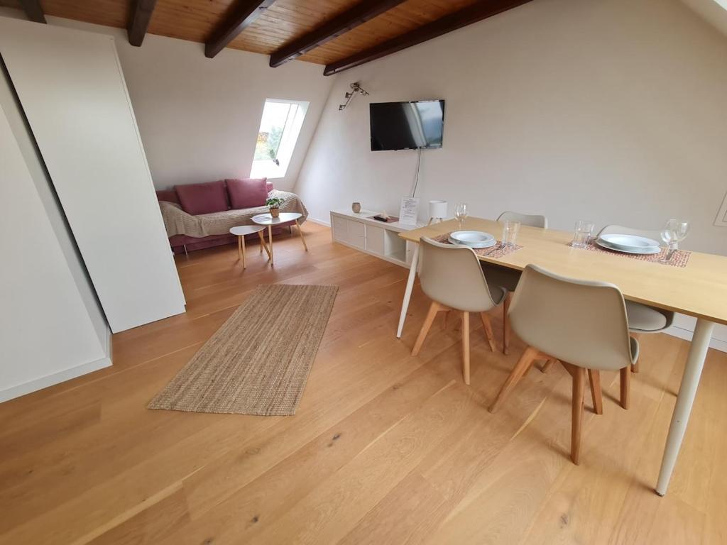 a living room with a table and chairs and a couch at Studio Apartment for 1-2 People with Rhine View in Rüdesheim am Rhein