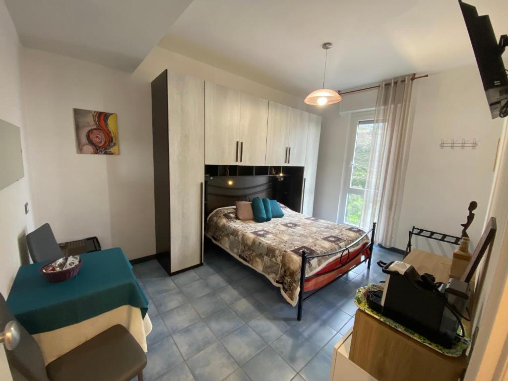 a bedroom with a bed and a couch in a room at Villa Caribe affittacamere in Monterosso al Mare