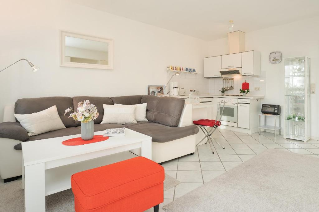 a living room with a couch and a table at Happy Place in Bojendorf