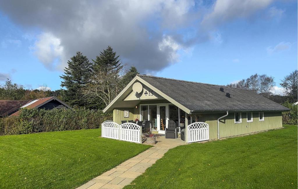 a small green building with a grass yard at 3 Bedroom Pet Friendly Home In Hemmet in Falen