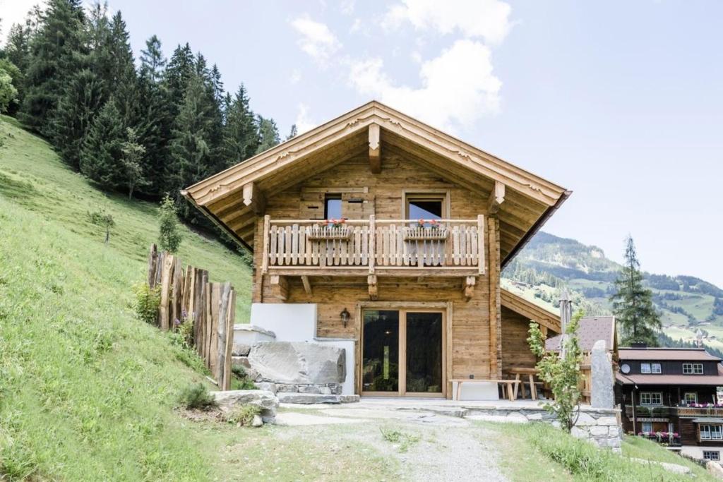 a log cabin on a hill with a balcony at Chalet Almrausch in Unterberg