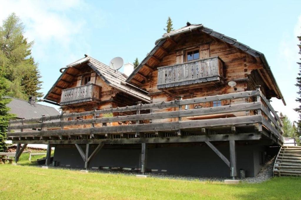 a log cabin with two windows on top of it at Alpine-Lodges Lisa in Hintersauerwald
