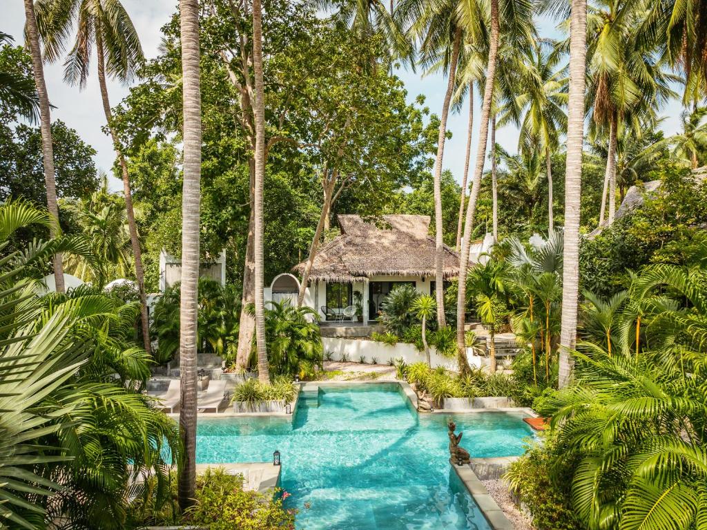 an aerial view of a resort pool with palm trees at Shanti Rock Residence Koh Phangan in Ko Kong Nui