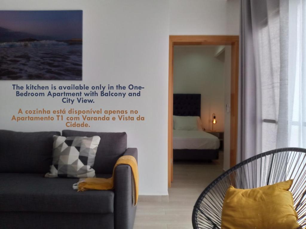 a living room with a couch and a bed at Charming House Tarrafal in Tarrafal