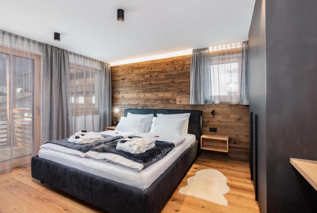 a bedroom with a large bed with a wooden wall at Aura in Isola Sacra