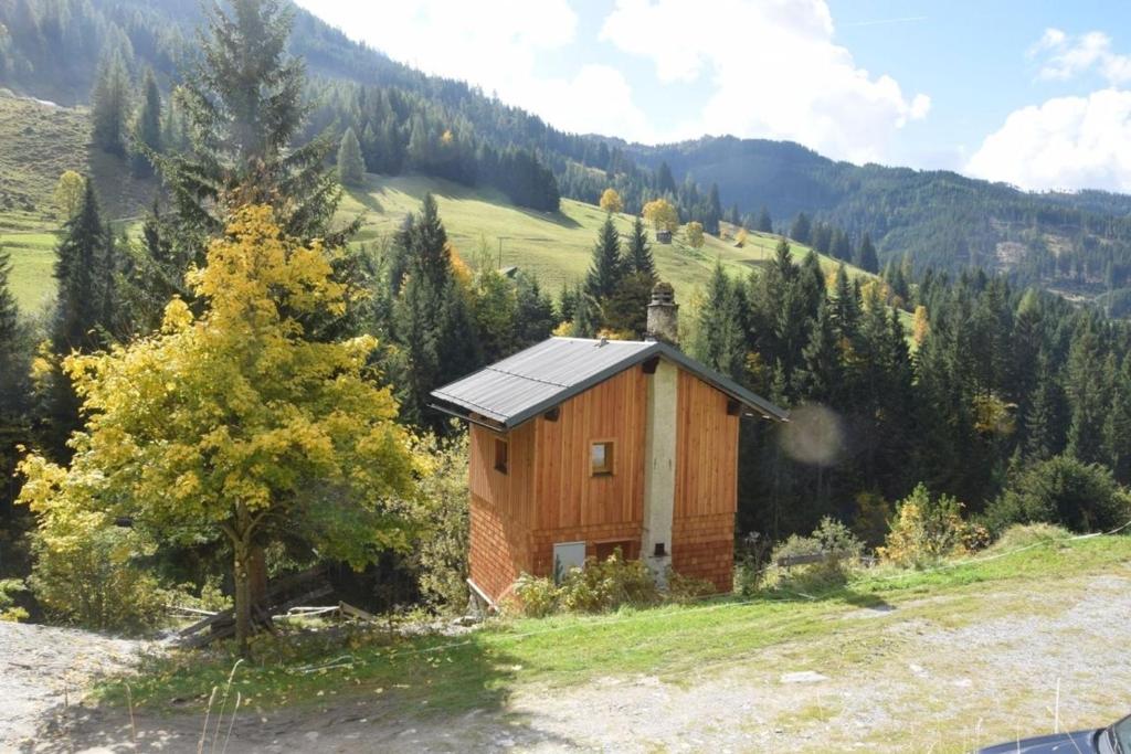 a small house with a solar roof on a mountain at Achtchalet in Grossarl