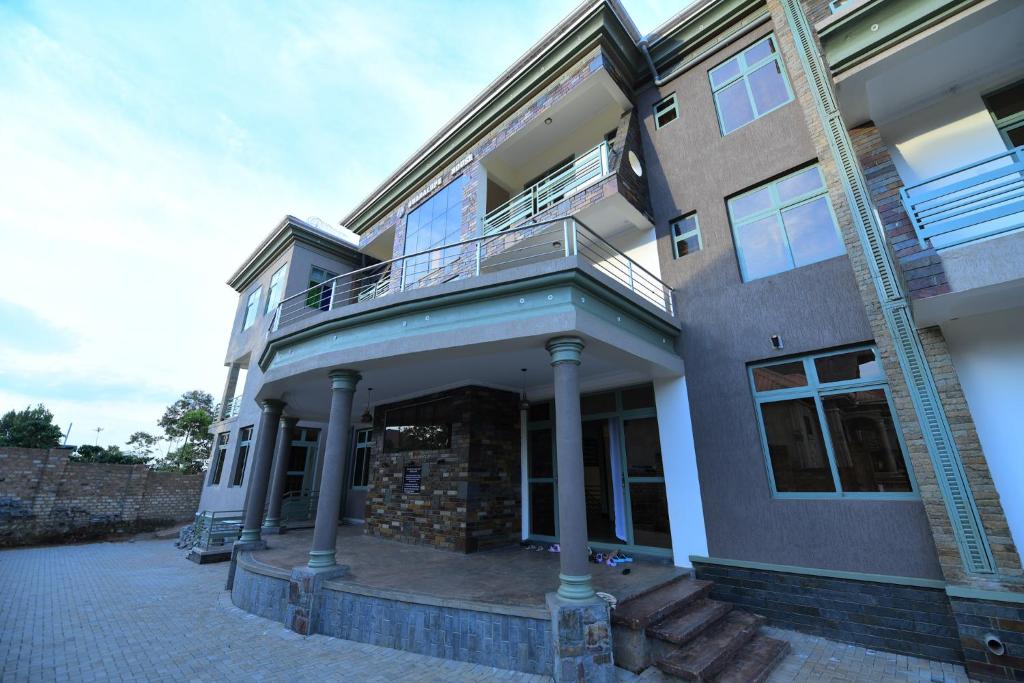 a large building with a balcony on top of it at Guadalupe house in Masaka
