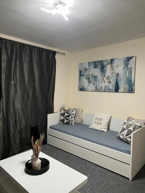 a living room with a couch with pillows on it at House in Manchester - G Escape in Manchester