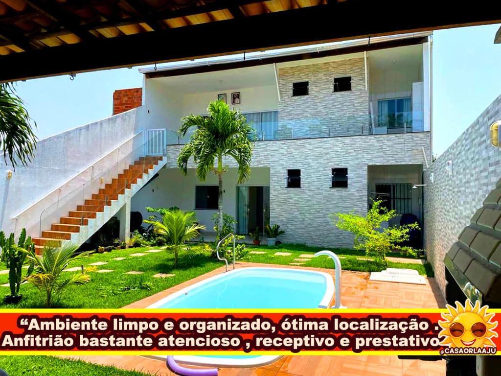 a house with a swimming pool in front of it at Casa da Orla - Piscina, Churrasqueira, 4 minutos da Orla Pôr do Sol in Aracaju