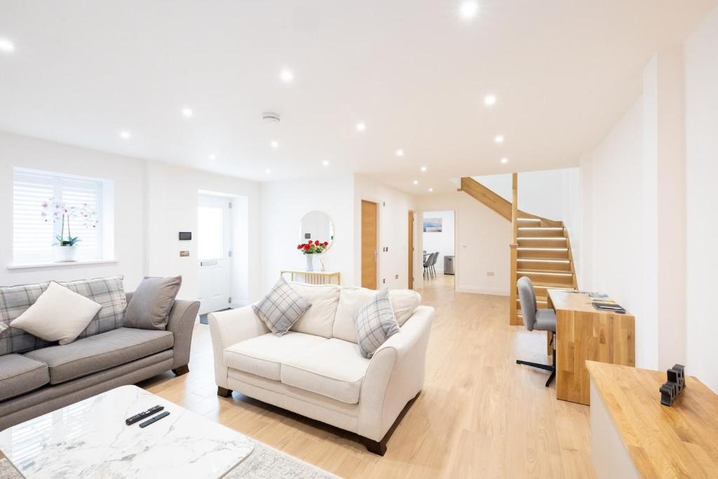a living room with a couch and a table at Granite cottage in Isle of Jersey