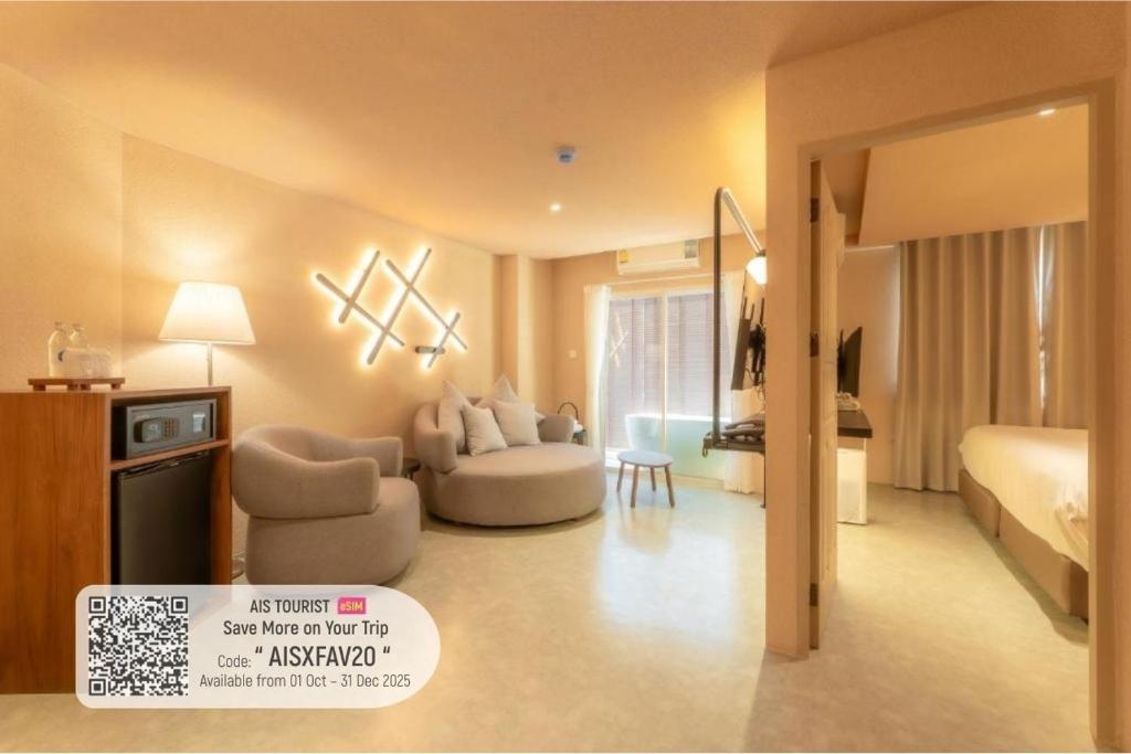 a hotel room with a bed and a living room at Mai Hotel Chiang Mai ใหม่โฮเทล เชียงใหม่ in Chiang Mai