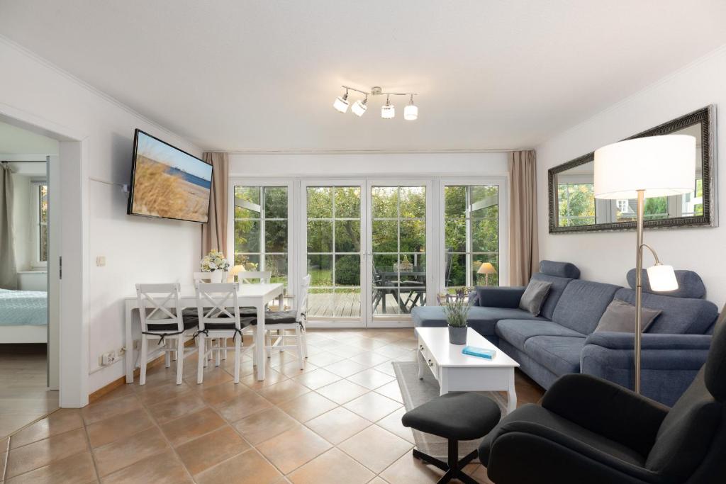 a living room with a couch and a table at Holunderbusch in Schönberger Strand