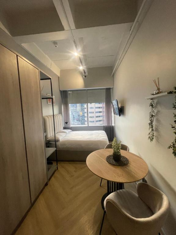 mały pokój z łóżkiem, stołem i stołem o wymiarach sześciu w obiekcie One Thibault Hotel - Cape Town City Centre w Kapsztadzie