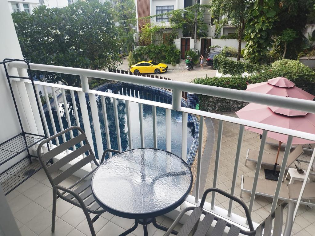 a table and two chairs on a balcony with a street at Arisara Nest in Bophut 