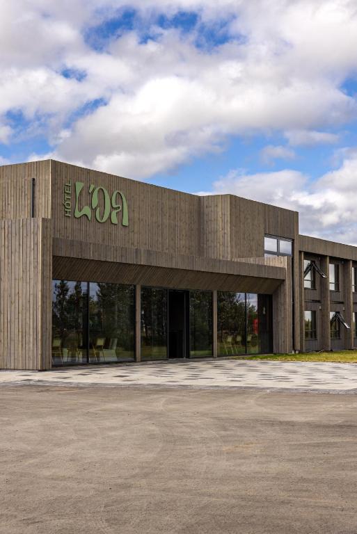 a building with a sign on the front of it at Hotel Loa in Hvolsvöllur
