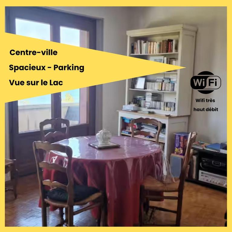 a dining room with a table with chairs and a table at Le Bellevue 2 in Thonon-les-Bains