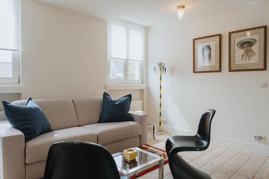 a living room with a couch and a table at Cozy Apartment in Central Antwerp in Antwerp