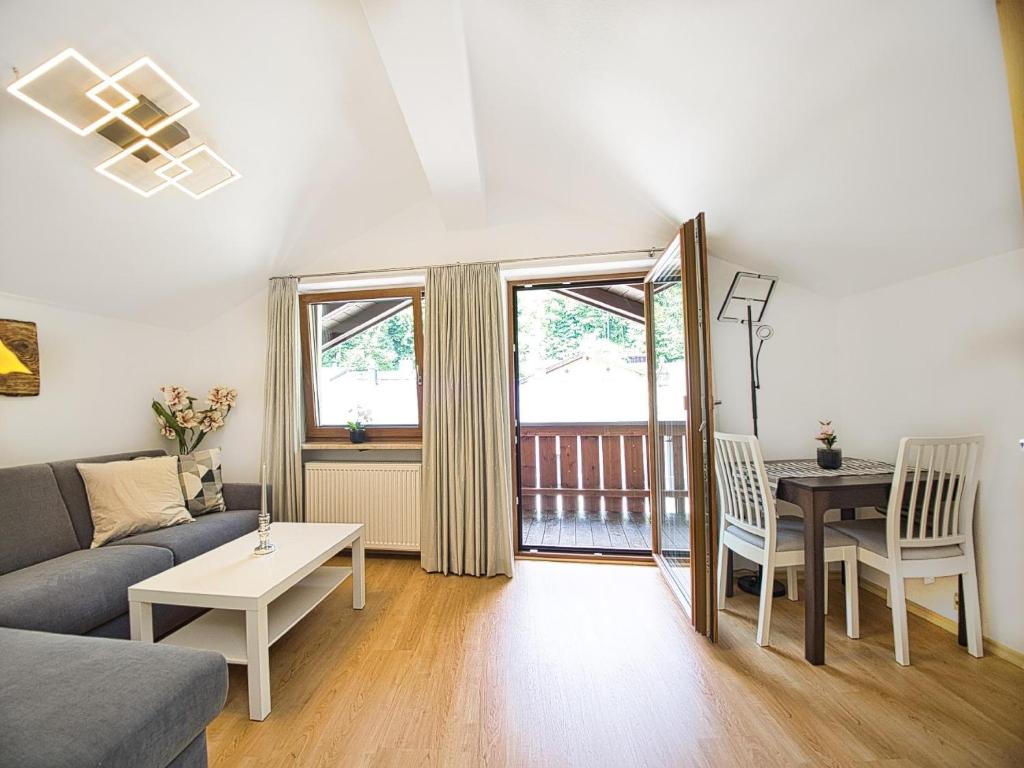 a living room with a couch and a table at Ferienwohnung Kehlsteinblick in Berchtesgaden