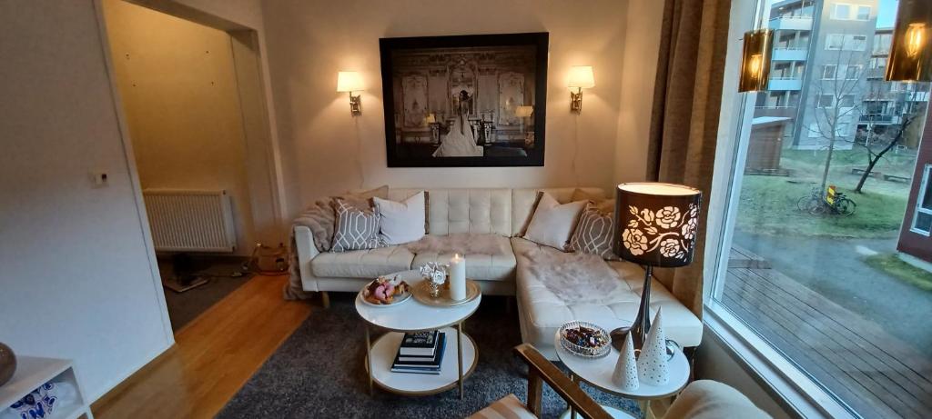 a living room with a couch and a table at Central apartment with 2 bedrooms in Tromsø