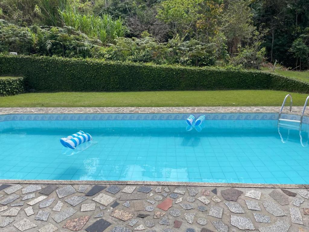 a swimming pool with two empty swimming tubes in it at Sítio D Ouro in Marechal Floriano