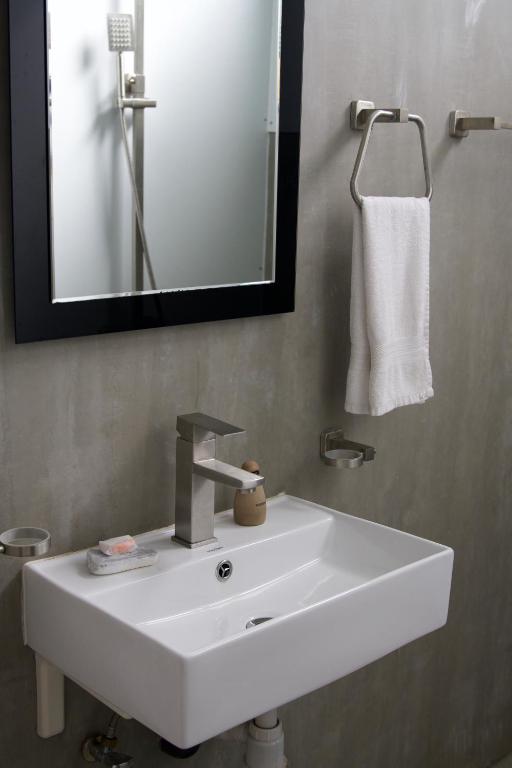a white sink in a bathroom with a mirror at Sapiens home - Weligama bay in Weligama