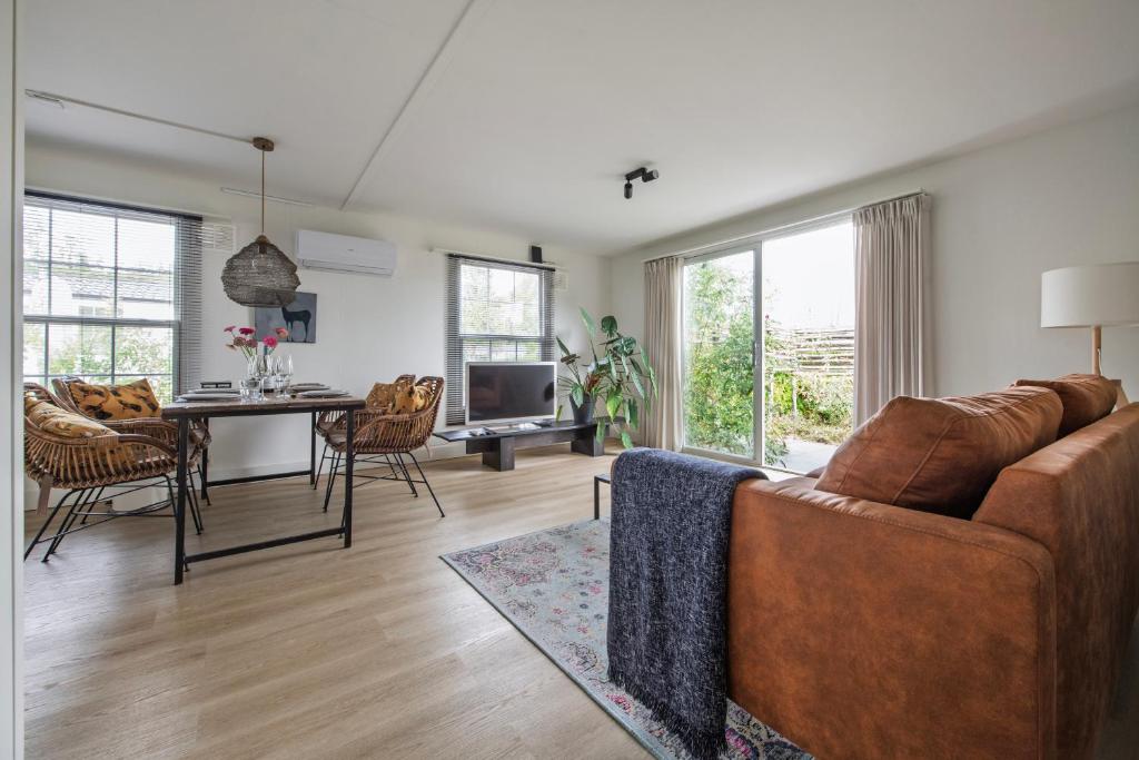 a living room with a couch and a table at 31, Ruimtelijk - Airco - Privé Parkeren - Natuur - Recreational Only in Oisterwijk