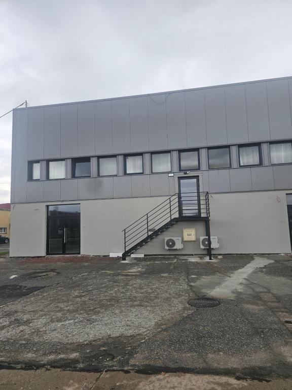 a large building with a staircase in front of it at MAR-VIT Apartamenty in Przemyśl