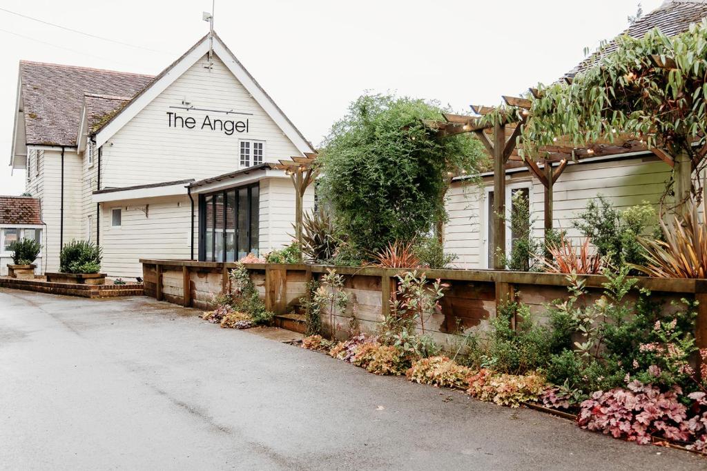 a white house with the angel written on it at The Angel Hotel in Alton