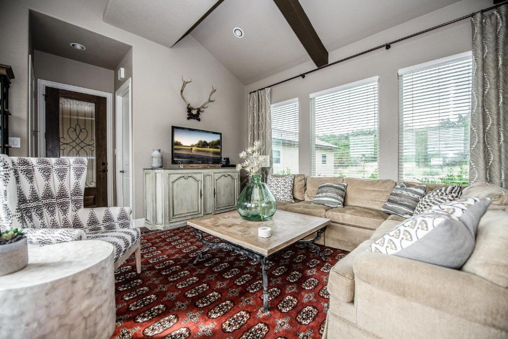 a living room with a couch and a table at Century Oak House - Main in Cranes Mill